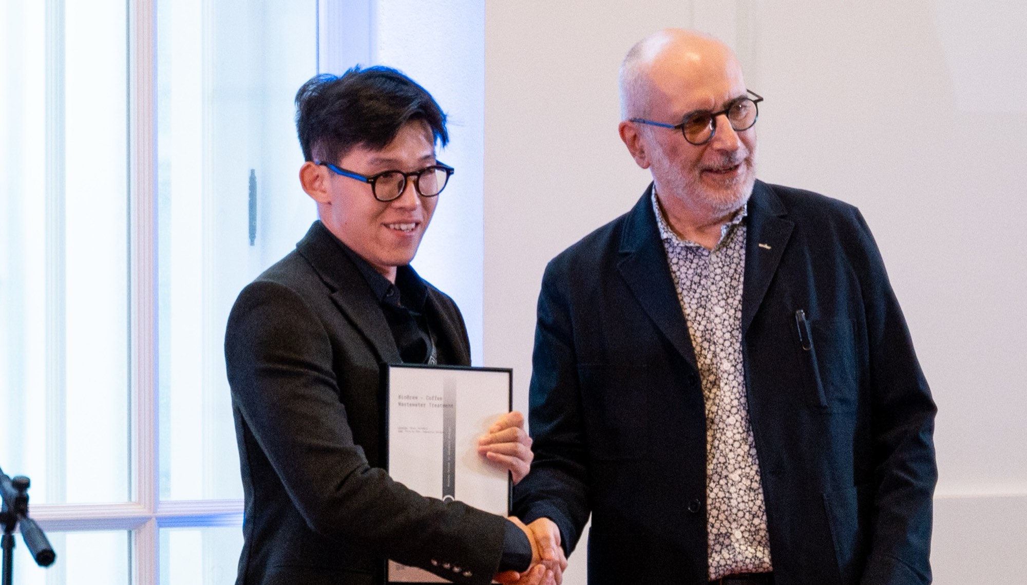 BioBrew, coffee wastewater treatment — a laureate is congratulated on stage
